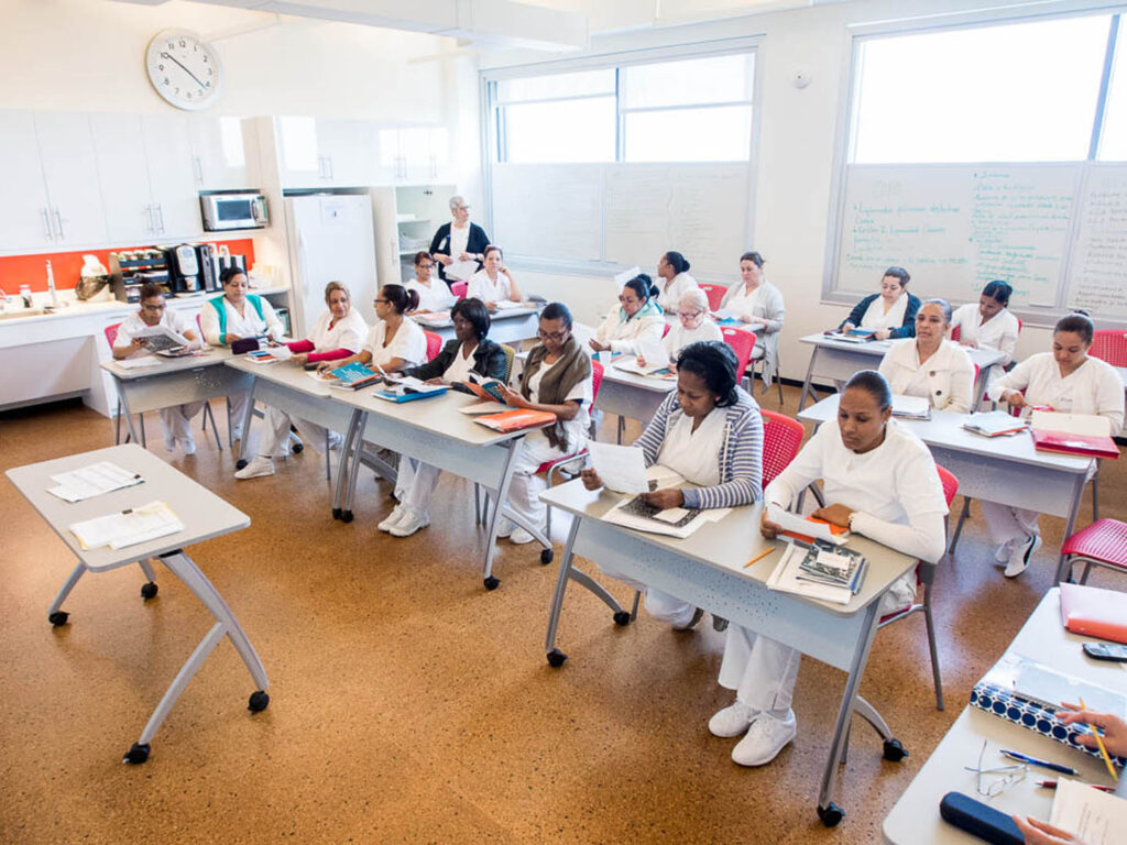 Students seated at desks at CHCA classroom training to be caregivers